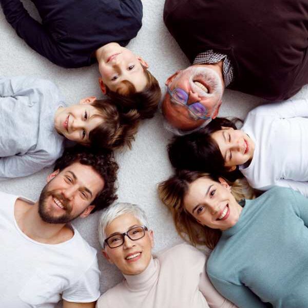 family-in-different-colours-of-clothes-lying-down-with-their-heads-close-to-each-other-in-building-strong-family-bonds
