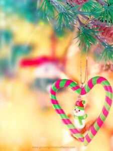 candy-cane-snowman-ornament-made-from-green-and-red-candies-hanged-on-achristmas-tree