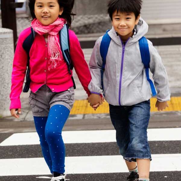Girl-in-blue-trouser-and-red-polo-holding-hands-with-a-boy-in-white-top-and-bue-trouser-in-practical-ways-to-raise-confidennt-and-independent-kids