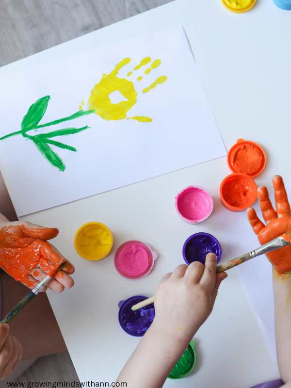 hands-of-kids-doing-handprint-flower-and-the-handprint-flower-thay-did.