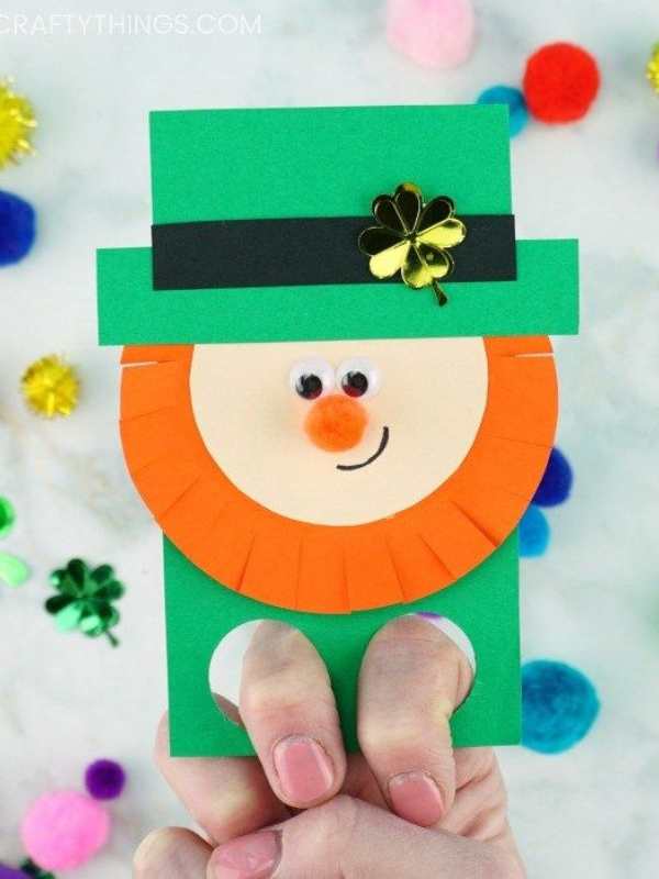 Leprechaun-finger-puppet-made-of-green-and-orange-colors-being-hold-in-a-finger.
