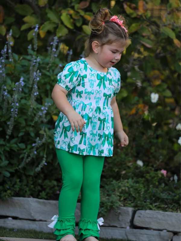 girl-wearing-a-bow-top-and-ruffled-leggings-in-lovely-st-patrick's-day-kids-outfits-ideas.