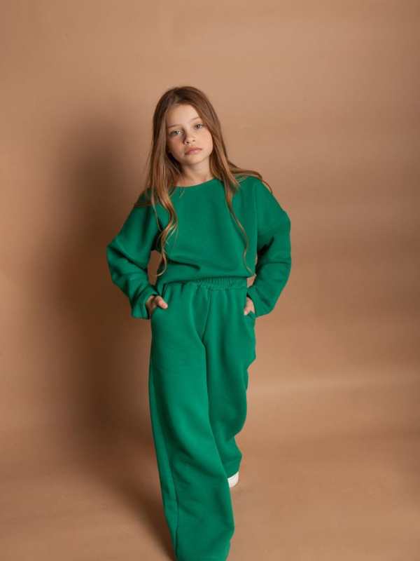 A-girl-wearing-green-polo-and-green-trousers-in-lovely-St.-Patrick's-day-kids-outfit-ideas.