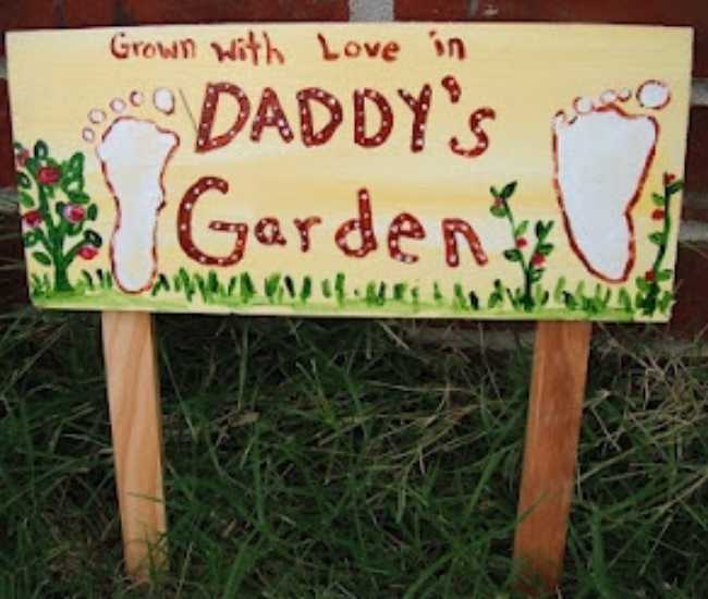 Wooden-garden-marker-written-grow-with-love-in-daddy's-garden-with-footprint-on-both-sides-in-adorable-father's-day-gift-ideas-from-kids.