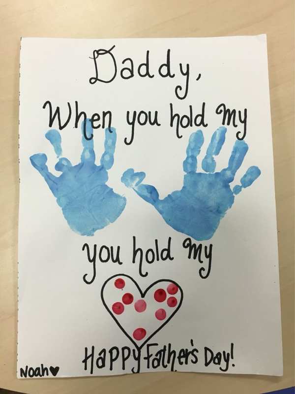 Card-designed-with-blue-handprint-and-written-daddy-when-you-hold-my-hand-you-hold-my-heart-in-adorable-father's-day-gift-ideas-from-kids.
