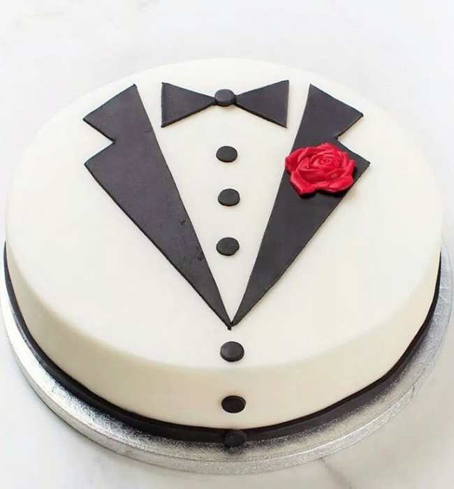Cake-designed-as-white-shirt-and-black-tie-with-red-rose-by-the-side.