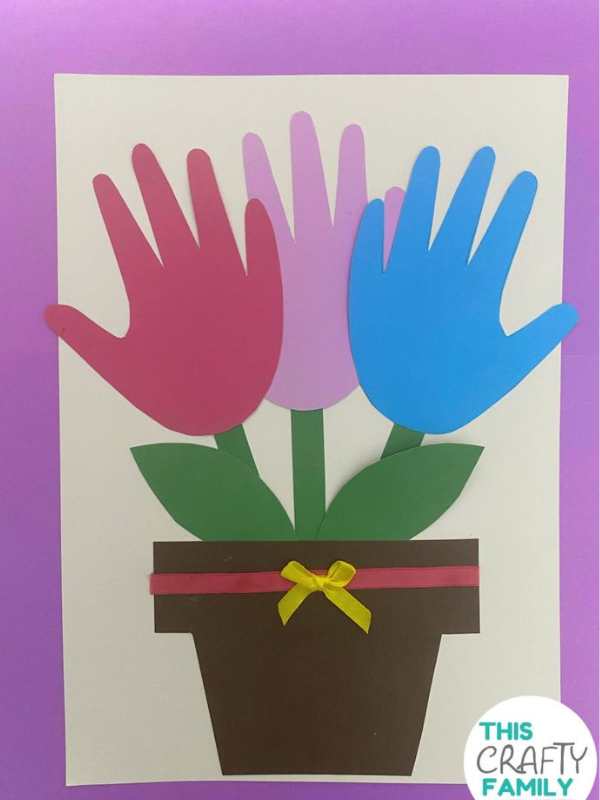 handprint-flower-pot-made-with-blue-red-green-pink--and-brown-colors
