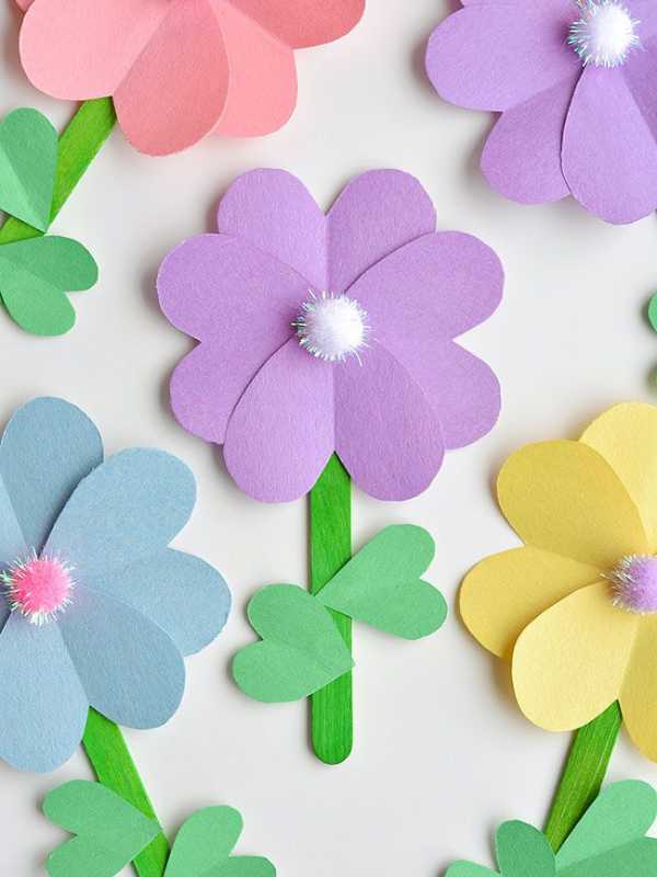 Popsicle-stick-painted-green-with-paper-of-different-colors-as-theflowers-to-form-popsicle-stick-flower.
