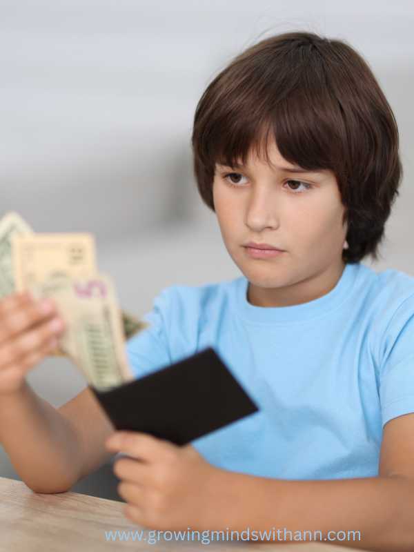 Boy-in-blue-holding-money-and-black-wallet-in-what-to-do-when-your-child-steals-calm-step-by-step-guide-for-moms.