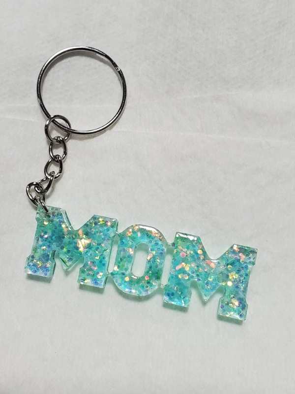 Resin-keychain-designed-with-blue-mom-alphabets.