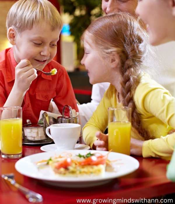 Boy-trying-to-feed-the-sister-during-family-meal.