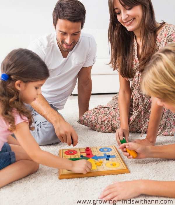 Mom-dad-and-their-children-playing-Ludo-game-in-motherhood-vision-board-intentional-parenting.