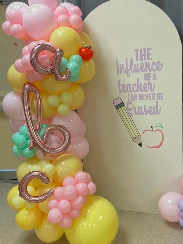 Inflated-balloons-of different-colors-used-for-decoration-close-to-a-board-written-the-influence-of-a-teacher-cannot-be-erased-in-creative-teacher's-day-decoration-ideas-for-classrooms.