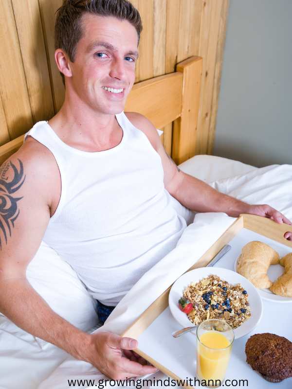 A-man-carrying-tray-of-breakfast-in-bed.