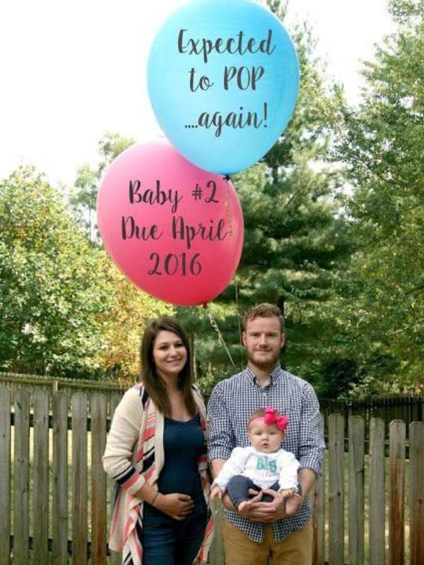Couple-with-their-child-with-pink-and-blue-balloon-popped-up.