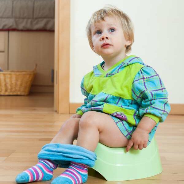 A-toddler-sitting-on-a-potty-in-clear-signs-your-toodler-is-ready-for-potty-training.