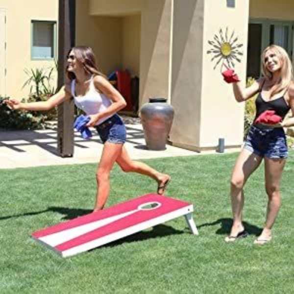 2-women-playing-cornhole-tournament-in-fun-and-memorable-ways-to-celebrate-4th-of-July-without-fireworks.