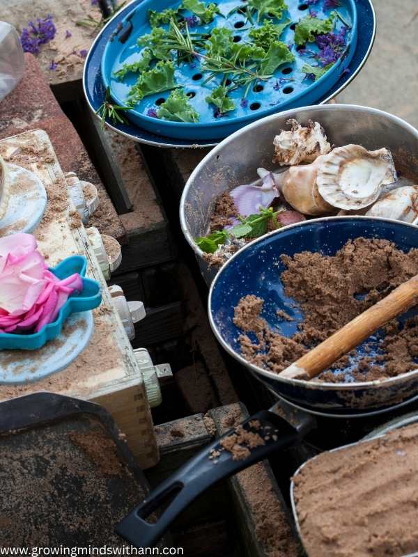 Pan-containing-sand-and-other-sensory-play-items.