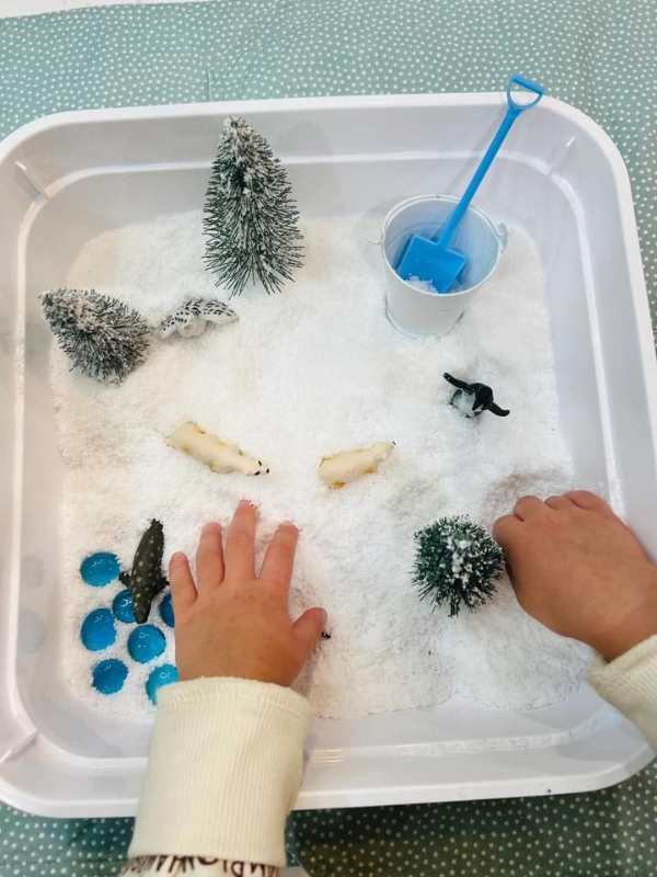 hands-playing-with-a-fake-snow.