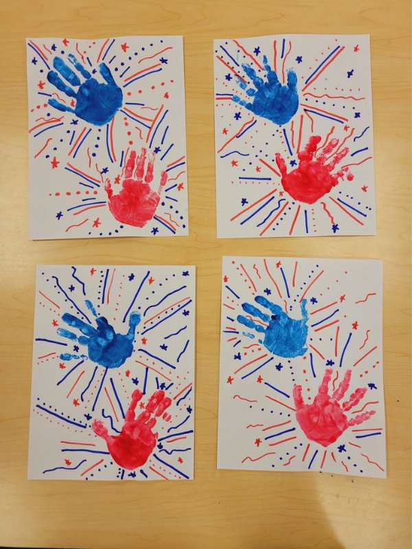 Red-and-blue-handprint-on-a-white-paper-with-red-and-blue-strokes-t-represent-fireworks.