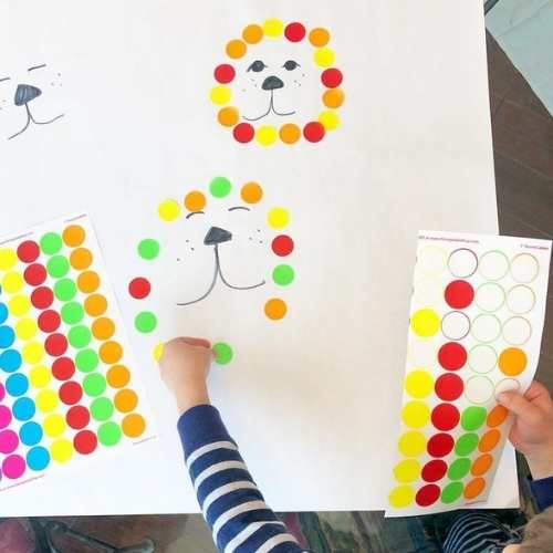 a-hand-peeling-and-sticking-stickers-on-paper-in-easy-sensory-activities-for-toddlers-and-preschoolers.
