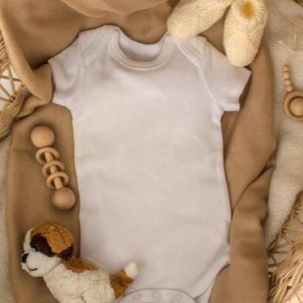 Baby-cloth-shoes-and-toys-lay-flat-on-a-surface-in-super-creative-pregnancy-announcement-ideas.