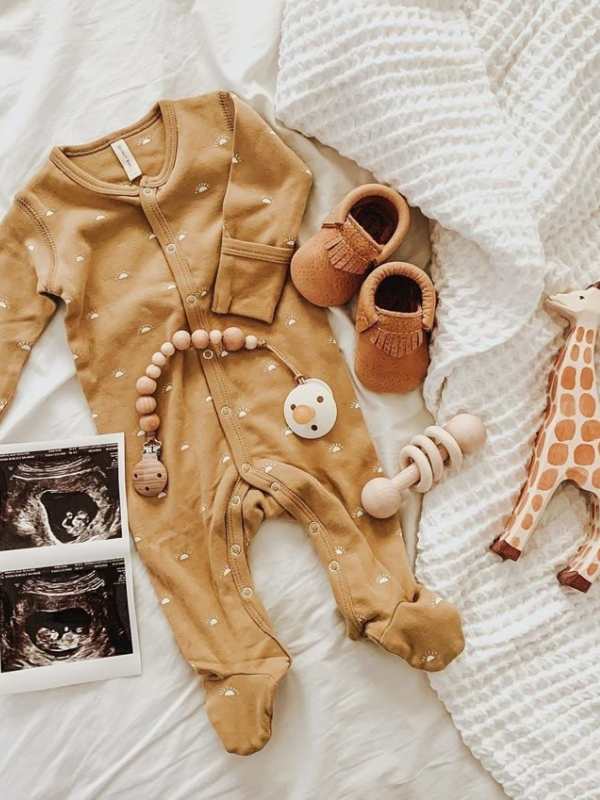 Baby-cloth-shoes-toys-and-ultrasound-result-lay-on-the-floor.