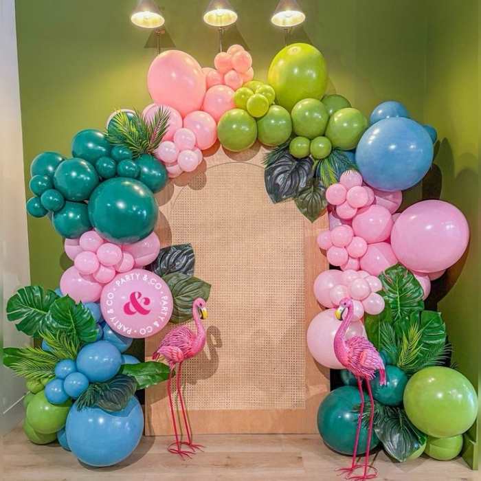 Balloon-arch-made-with-green-lemon-blue-and-pink-balloon-with-flamingo-on-both-sides.