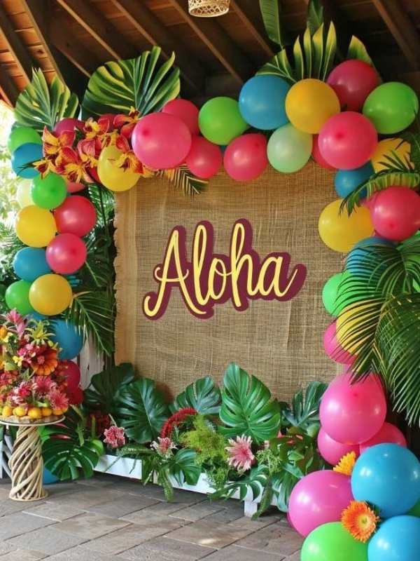 Ballon-arch-roun-a-board-with-palm-leaves-around-it-in-cute-and-affordable-tropical-baby-shower-theme-ideas.