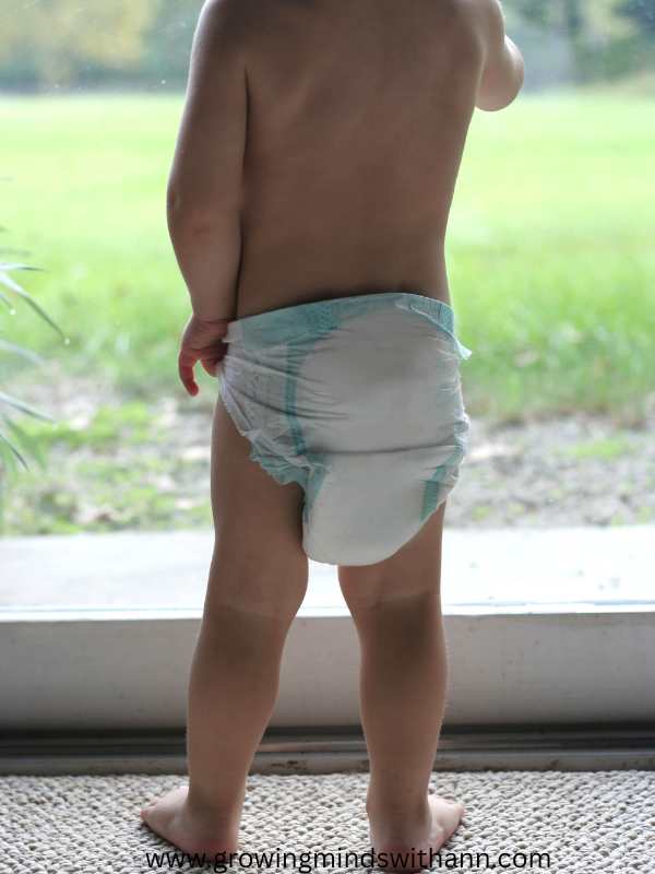 Toddler-pulling-his-diaper-down.