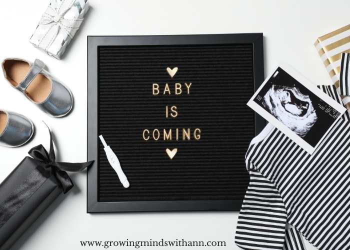 Black-board-written-baby-is-coming-baby-shoe-cloth-and-ultrasound-result-round-it.