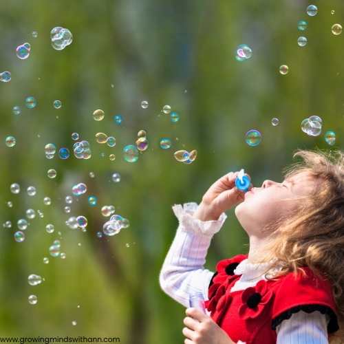 A-child-blowing-bubbles-into-the-air.