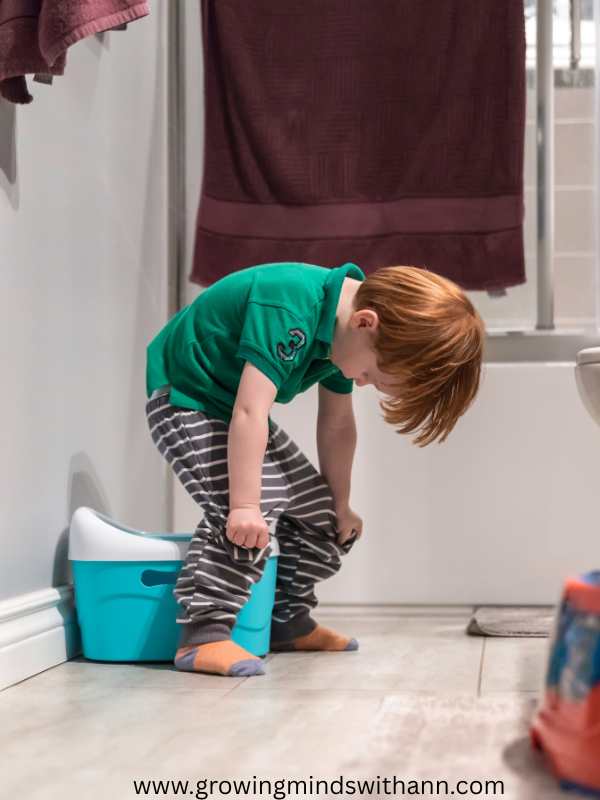 toddler-pulling-down-his-pants-in-clear-signs-your-toddler-is-ready-for-potty-training.