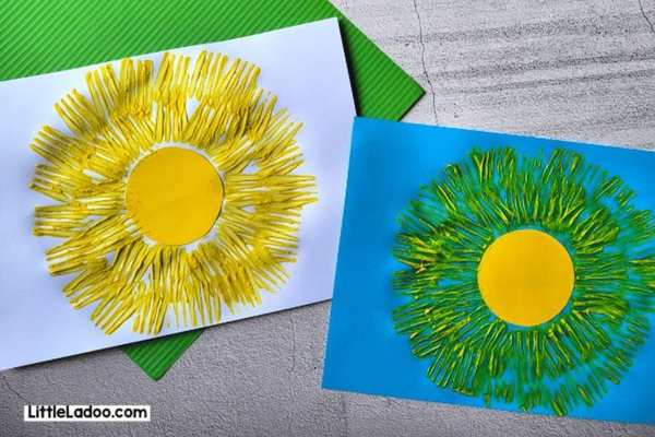 2-fork-painted-sun-crafts-on-blue--and-white-paper.