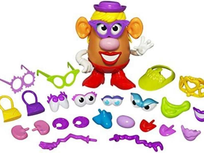 Mrs-potato-head-standing-wit-the-parts--and-pieces-of-her-suitcase-on-the-floor.
