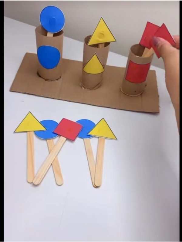 Popsicle-stick-glued-with-different-shapes-and-cups-with-the-same-shapes-as-the-stick-on-them-in-popsicle-stich-matching-activities-for-toddlers.
