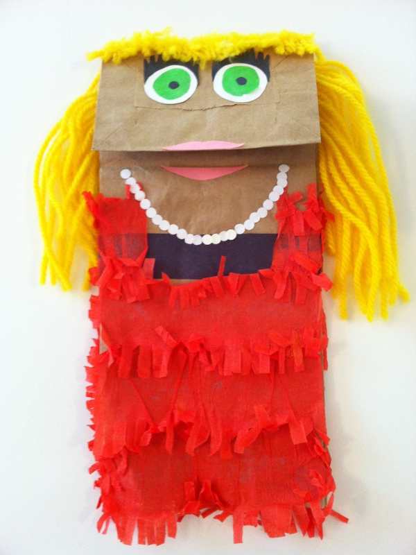 Paper-bag-puppet-made-with-red-and-yellow-yarn-with-blue-goggle-eyes-in-summe-crafts-for-kids.