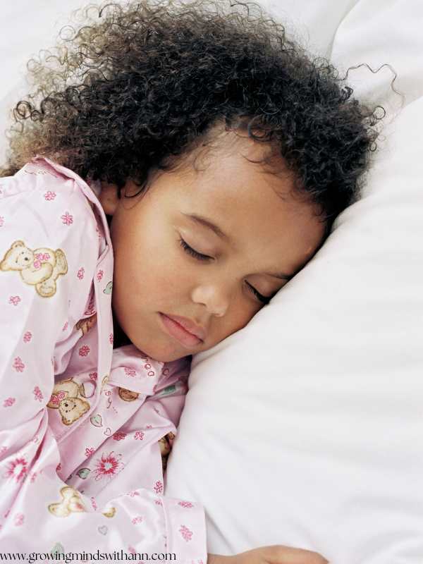 Girl-sleeping-on-a-bed-in-back-to-school-sleeping-schedule-for-kids.