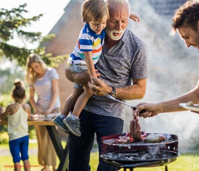 Father-roasting-barbecue-with-mom-and-kids-around.