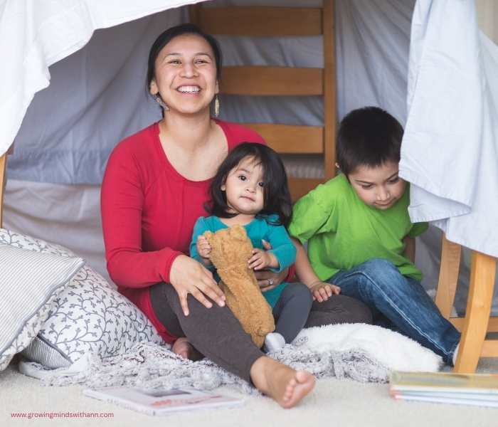 Mom-and-two-kids-inside-a-fort-in-summer-bucket-list-ideas-for-families.