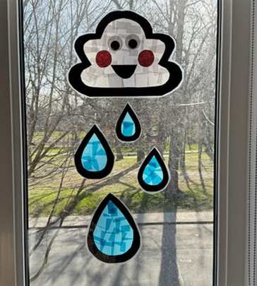 Cloud-sun-catcher-displayed-on-a-window-in-sun-catcher-crafts-for-kids.