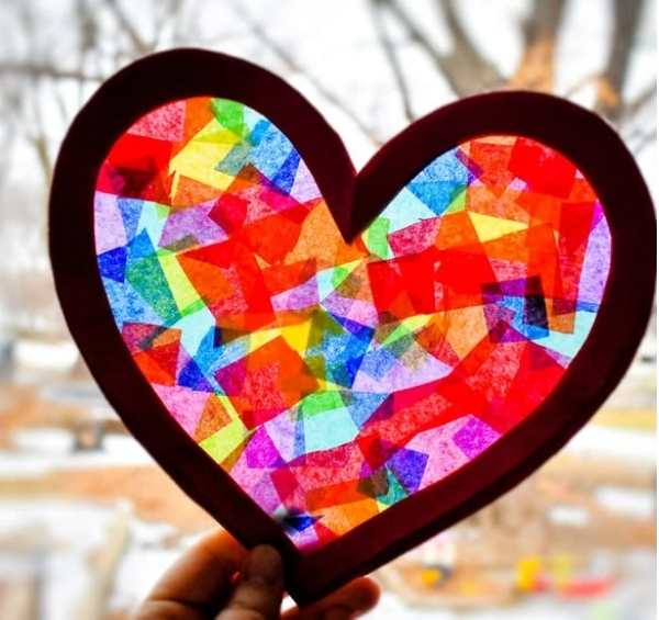 Heart-sun-catcher-crafts-held-up-to-the-sun-in-sun-catcher-crafts-for-kids.