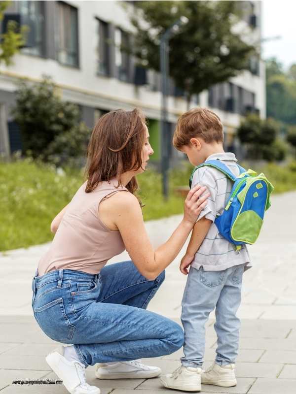 Mom-adjusting-her-child's-cloth-while-talking-to-him-in-how-to-prepare-your-child-for-their-first-day-of-school.