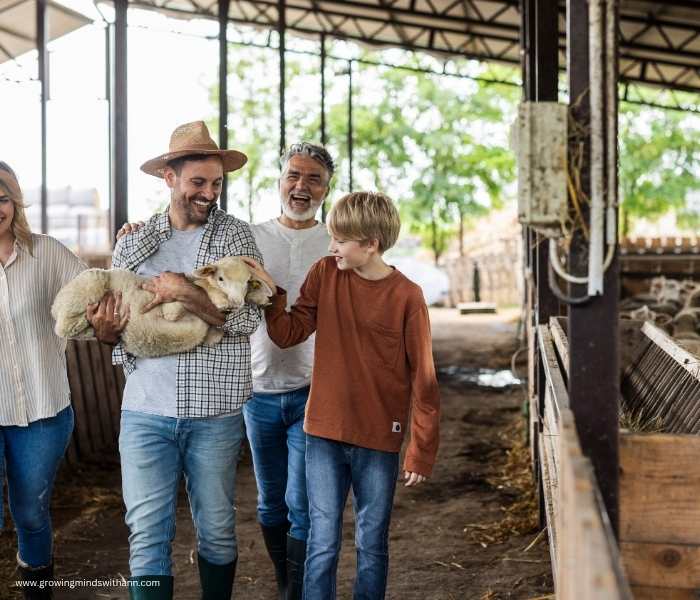 Father-holding-lamb-walking-with-mom-and-two-sons-in-a-farm.