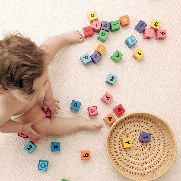 Toddler-picking-plastic-alphabet-and-putting-in-a-basket-in-low-prep-homeschool-activities-for-busy-moms.