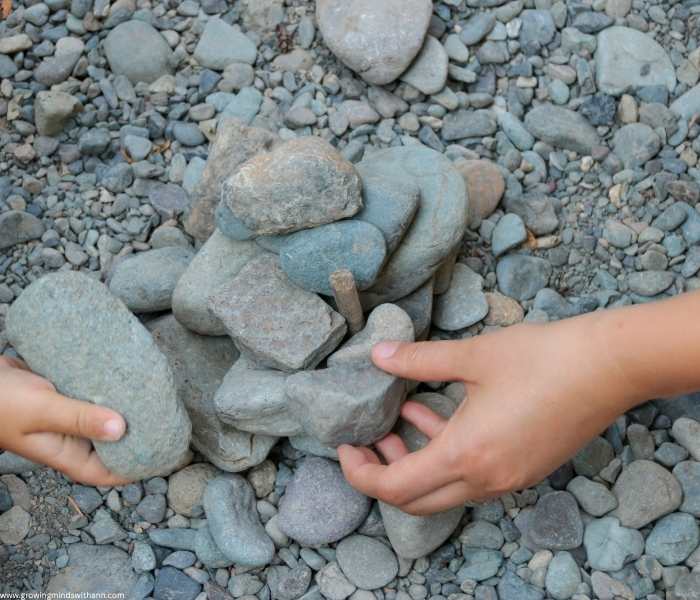hands-picking-pebbles-in-low-prep-homeschooling-activities-for-busy-moms.