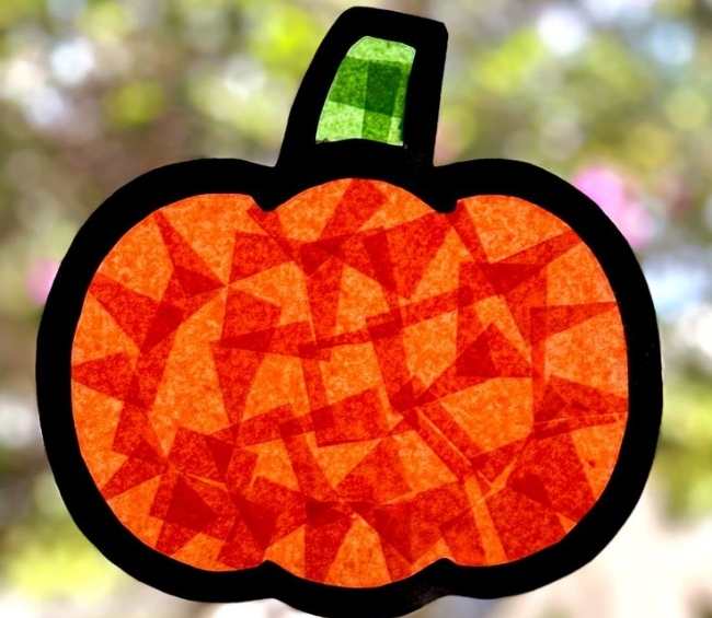 Pumpkin-sun-catcher-displayed-on-a-window-in-sun-catcher-crafts-for-kids.