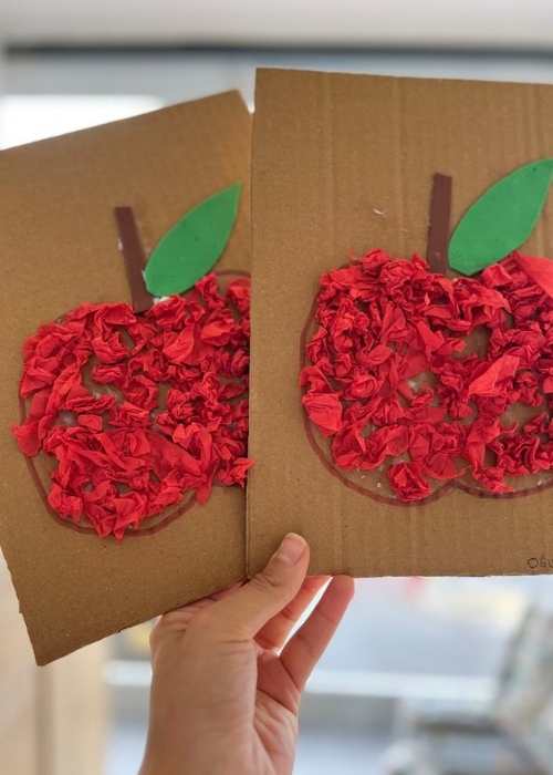 Red-scrunched-paper-apple-on-a-brown-carton-in-harvest-craft-ideas-for-kids-that-are-easy-and-fun.