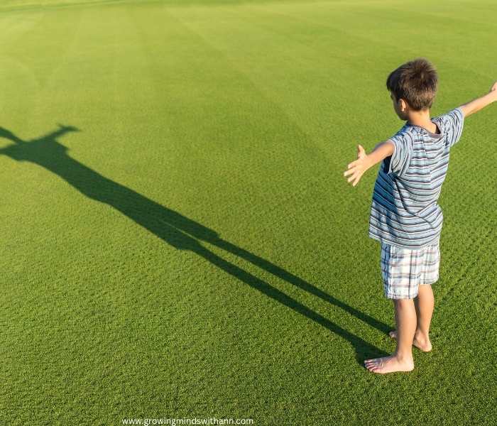 A-boy-standing-and-watching-his-shadow.