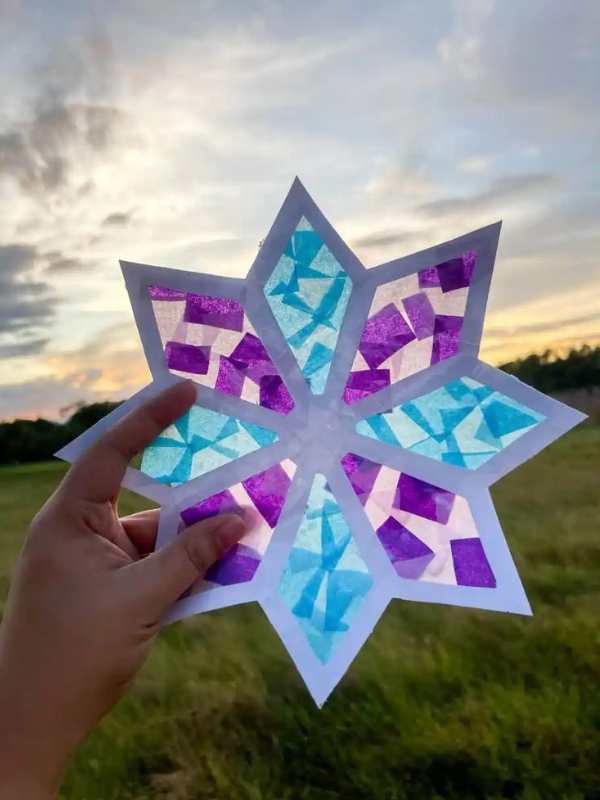 Snowflakes-Sun-catcher-held-up-to-the-sky.